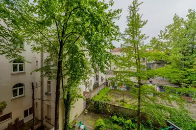 a view from the balcony of a building with trees at Charming One Bedroom In The Heart of Belgrade in Belgrade