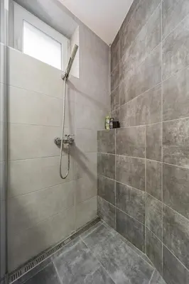 a shower stall in a bathroom with a window at Charming One Bedroom In The Heart of Belgrade in Belgrade