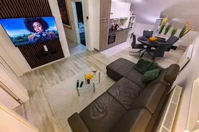 an overhead view of a living room with a brown couch at Oaza Apartmani Jakovo APOLON SPA in Jakovo