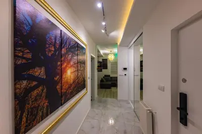 a hallway with a large painting on the wall at Oaza Apartmani Jakovo APOLON SPA in Jakovo