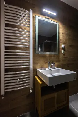a bathroom with a white sink and a mirror at Oaza apartmani Jakovo VENERA in Jakovo