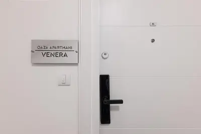 a white door with a sign on it at Oaza apartmani Jakovo VENERA in Jakovo