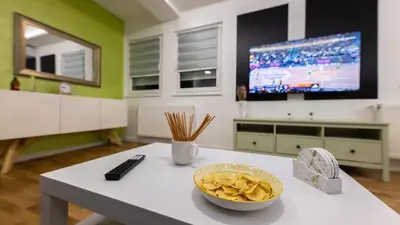 a living room with a table with a bowl of chips at Oaza apartmani Jakovo VENERA in Jakovo