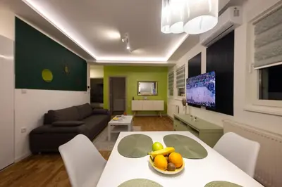 a living room with a table with a bowl of fruit on it at Oaza apartmani Jakovo VENERA in Jakovo