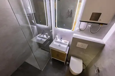 a bathroom with a toilet and a sink and a shower at Oaza Apartmani Jakovo AFRODITA in Jakovo