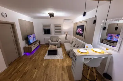 a living room with a couch and a table at Oaza Apartmani Jakovo AFRODITA in Jakovo