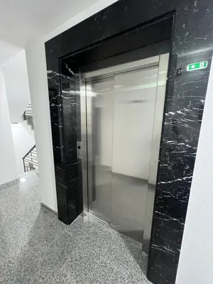 an elevator with a glass door in a building at Loyal 1 in Arandjelovac
