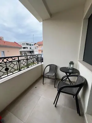 a balcony with two chairs and a table on a balcony at Loyal 1 in Arandjelovac