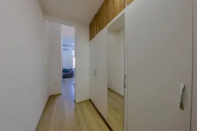 a hallway with white walls and wooden floors at Cozy Little Place - Parking Available in Belgrade