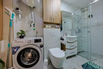 a bathroom with a washing machine and a toilet at Cozy Little Place - Parking Available in Belgrade