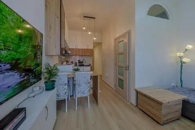 a kitchen with a table and chairs in a room at Cozy Little Place - Parking Available in Belgrade
