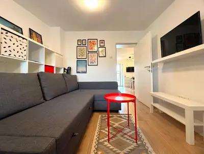 a living room with a couch and a red stool at Maria Belgrade Center in Belgrade