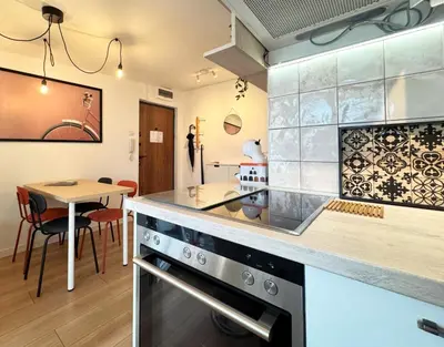 a kitchen with a stove and a dining room at Maria Belgrade Center in Belgrade