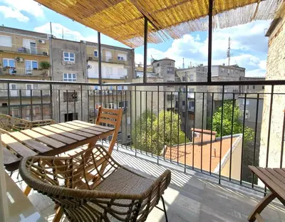 a balcony with a table and chairs on a building at Maria Belgrade Center in Belgrade