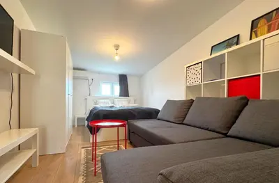 a living room with a couch and a red stool at Maria Belgrade Center in Belgrade