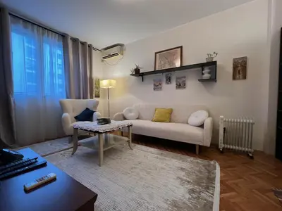a living room with a couch and a table at Belgrade Central Residence in Belgrade