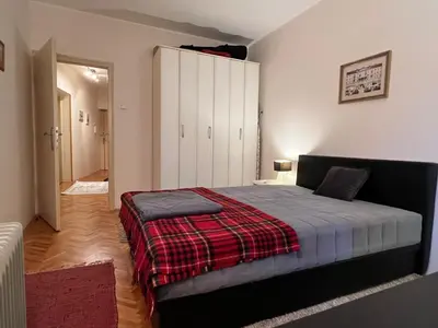 a bedroom with a bed with a red blanket at Belgrade Central Residence in Belgrade