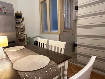 a dining room with a table and white chairs at Belgrade Central Residence in Belgrade