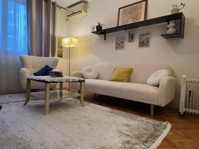 a living room with a couch and a table at Belgrade Central Residence in Belgrade
