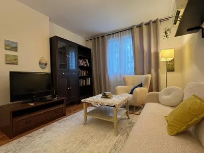 a living room with a couch and a tv at Belgrade Central Residence in Belgrade