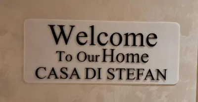 a sign on a wall that says welcome to our home in casa delragon at LUX Casa di Stefan in Belgrade