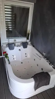 a white bath tub in a room with a window at LUX Casa di Stefan in Belgrade