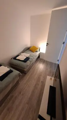 a small room with a bed and a table at LUX Casa di Stefan in Belgrade