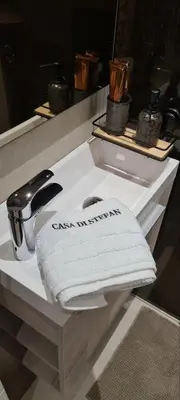 a bathroom sink with a white towel on a counter at LUX Casa di Stefan in Belgrade