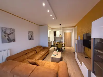 a living room with a couch and a table at Beograd na vodi Lux apartman BW Magnificent City View in Sajmište