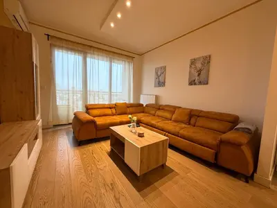 a living room with a couch and a coffee table at Beograd na vodi Lux apartman BW Magnificent City View in Sajmište