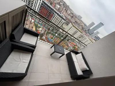 a room with two beds and a tv in a building at Beograd na vodi Lux apartman BW Magnificent City View in Sajmište