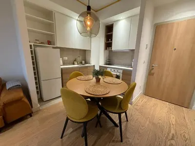 a kitchen with a table and chairs in a room at Beograd na vodi Lux apartman BW Magnificent City View in Sajmište