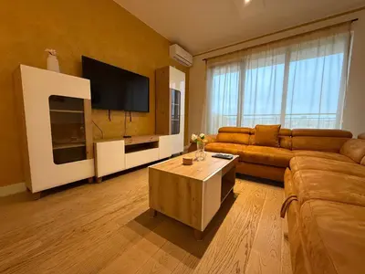 a living room with a couch and a flat screen tv at Beograd na vodi Lux apartman BW Magnificent City View in Sajmište