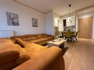 a living room with a couch and a table at Beograd na vodi Lux apartman BW Magnificent City View in Sajmište