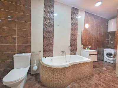 a bathroom with a tub and a toilet and a sink at Skaradlija Lux Apartment in Belgrade