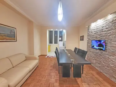 a living room with a table and a couch at Skaradlija Lux Apartment in Belgrade