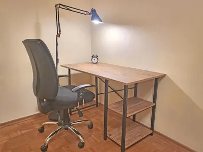 an office desk with a chair and a lamp at Skaradlija Lux Apartment in Belgrade