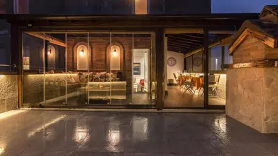 a room with glass doors and a dining room at Belgrade Penthouse - among the clouds in Belgrade