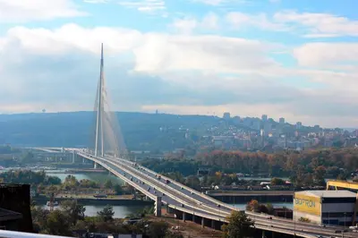 a bridge over a river with a city in the background at Belgrade Penthouse - among the clouds in Belgrade