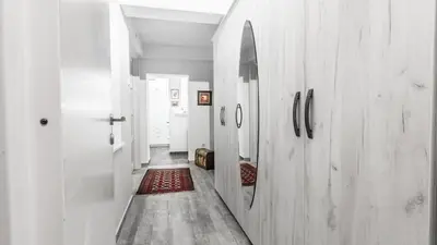 a hallway with white walls and a red rug at Belgrade Penthouse - among the clouds in Belgrade