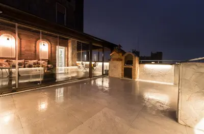 a building with a lit up patio at night at Belgrade Penthouse - among the clouds in Belgrade