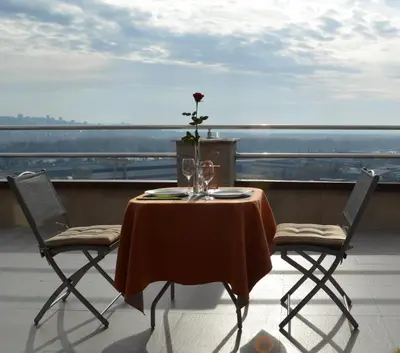 a table and two chairs on a balcony with a view at Belgrade Penthouse - among the clouds in Belgrade