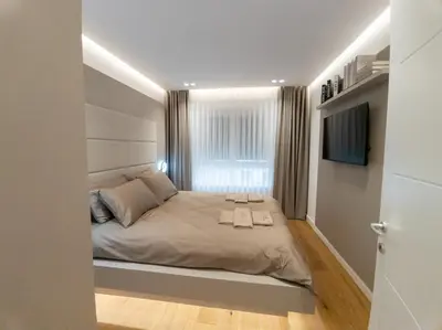 a bedroom with a bed and a window at Lux Brilijant Apartmant in Belgrade