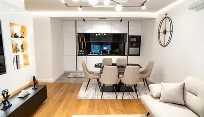 a living room and dining room with a table and chairs at Lux Brilijant Apartmant in Belgrade