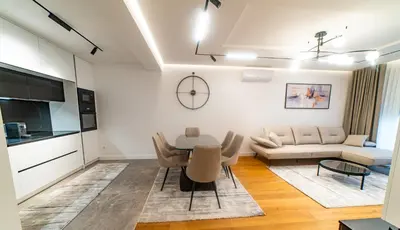 a living room with a table and a couch at Lux Brilijant Apartmant in Belgrade