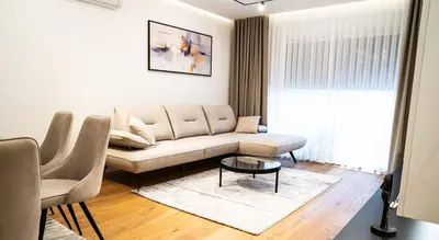 a living room with a couch and a table at Lux Brilijant Apartmant in Belgrade