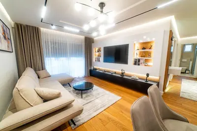 a living room with a couch and a tv at Lux Brilijant Apartmant in Belgrade