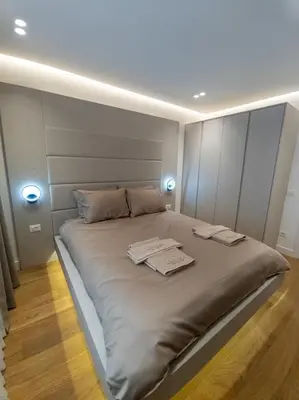 a bed in a room with two towels on it at Lux Brilijant Apartmant in Belgrade