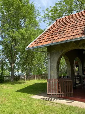 a gazebo with a red roof in a park at Vikendica Lela in Beška
