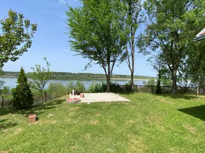 a picnic area with a view of the water at Vikendica Lela in Beška